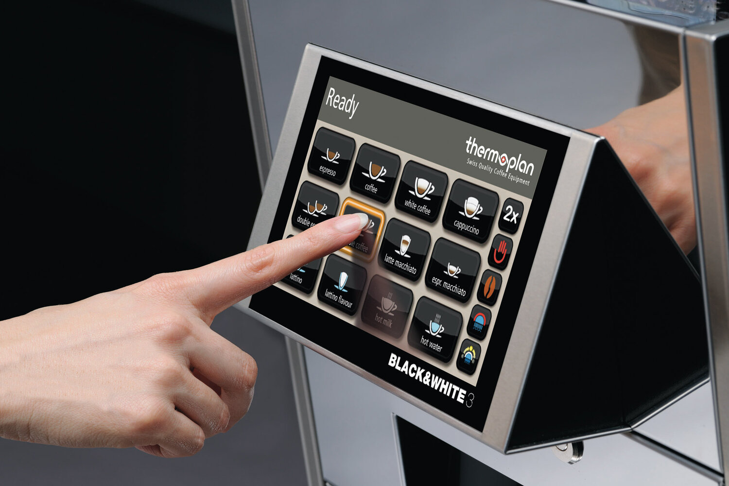 Finger operates touch display on a fully automatic coffee machine